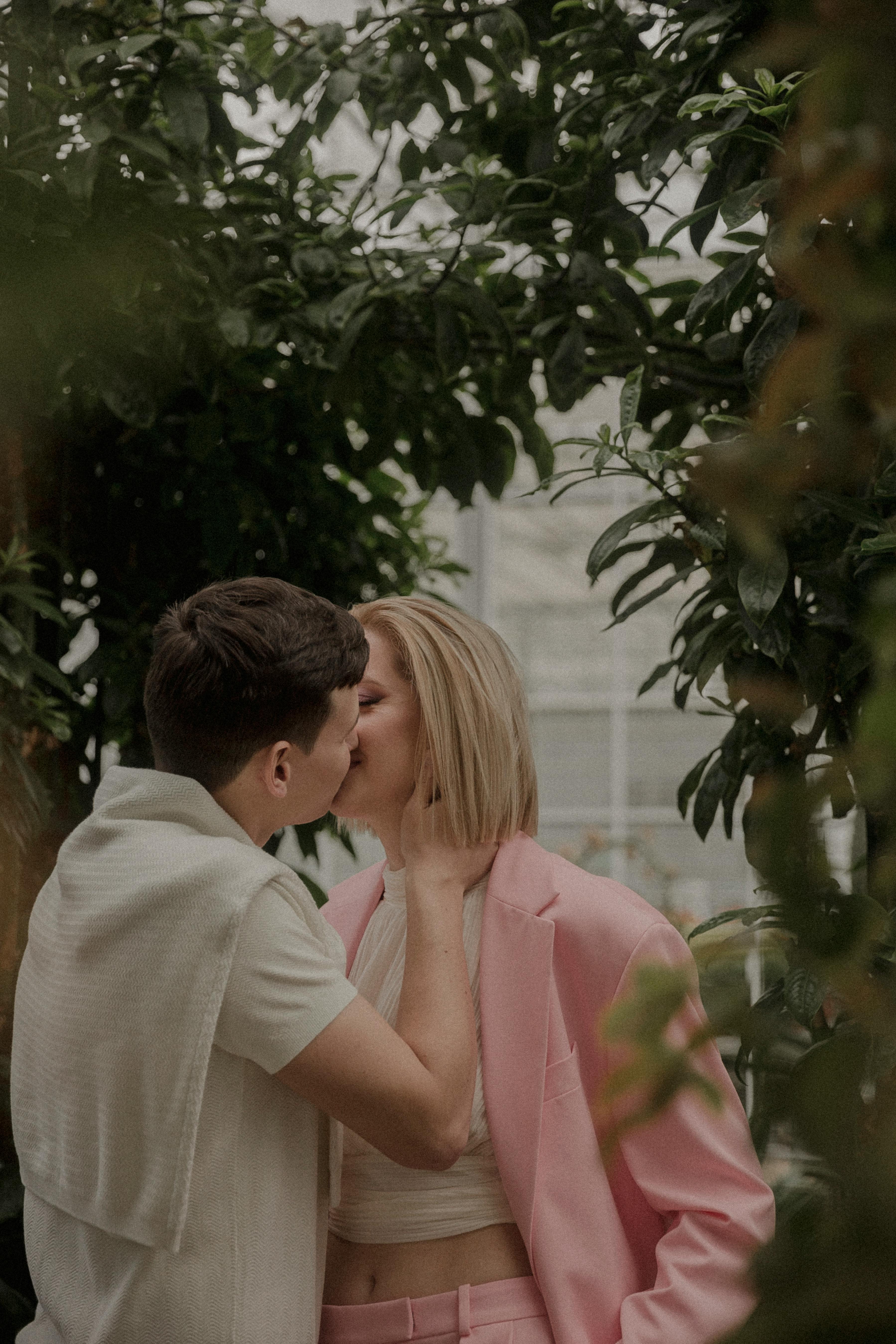 Photo of a Young Couple Kissing in the Rice Fields · Free Stock Photo