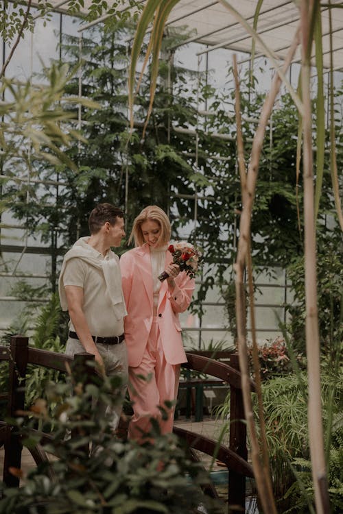 Happy Cheerful Couple in Greenhouse