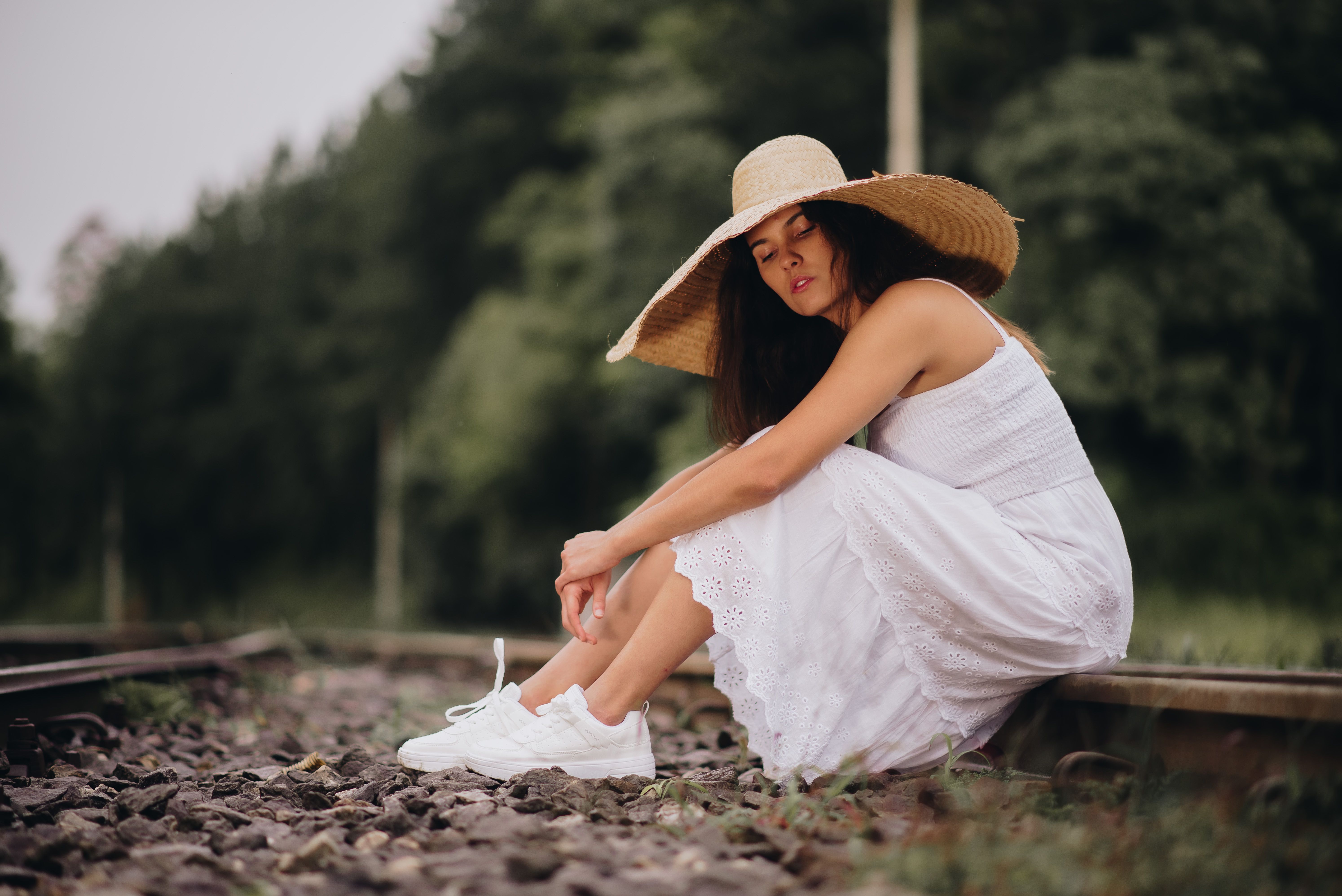 Woman Sitting on Rail Tracks · Free Stock Photo