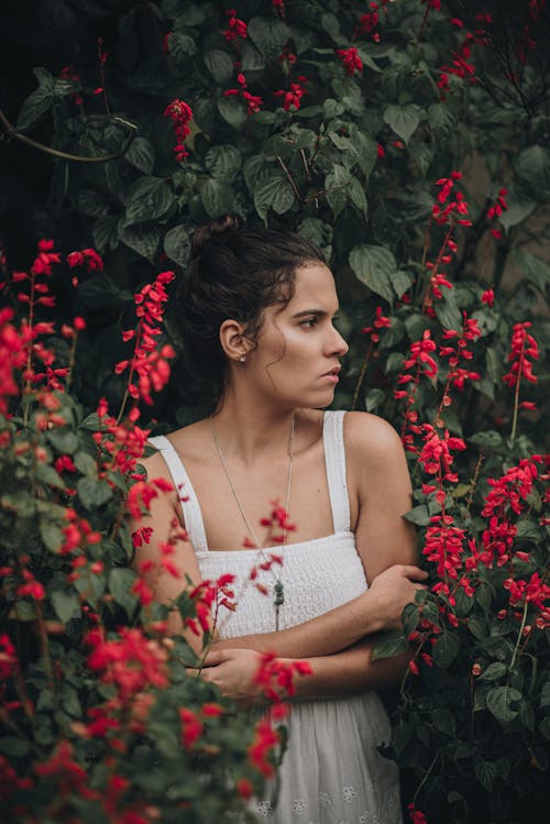 Woman in White Dress among Flowers