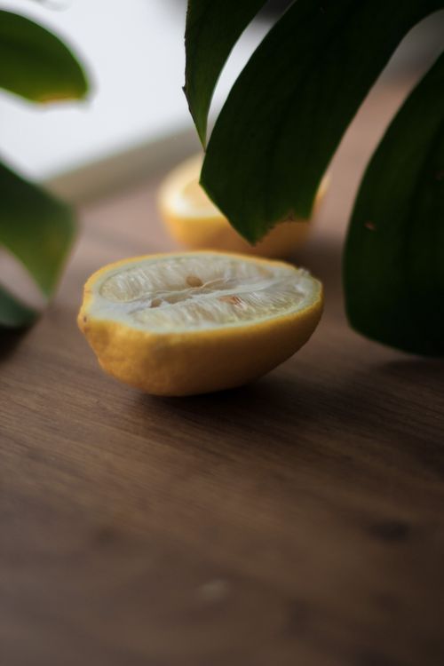 Free Close-up of lemon halves with green leaves, showcasing freshness and natural aroma. Stock Photo