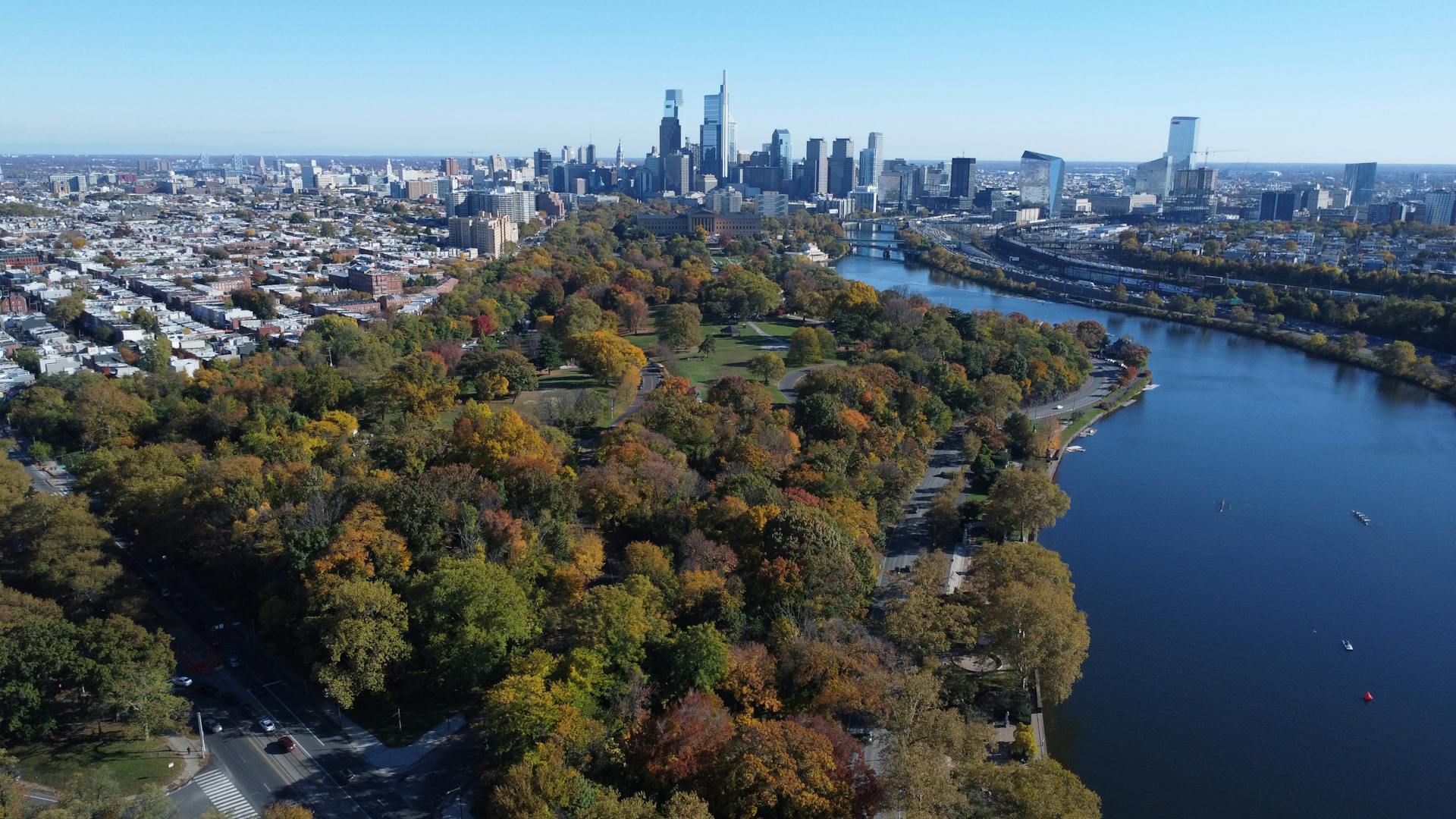 Stunning aerial shot of Philadelphia's skyline with Fairmount Park and Schuylkill River in fall colors.