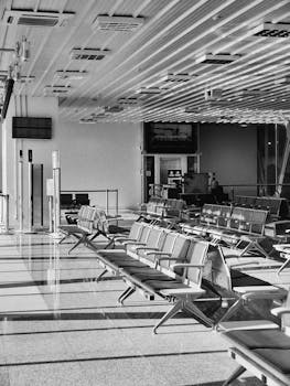 A tranquil, empty airport waiting area in Cascavel, Brazil, in black and white.
