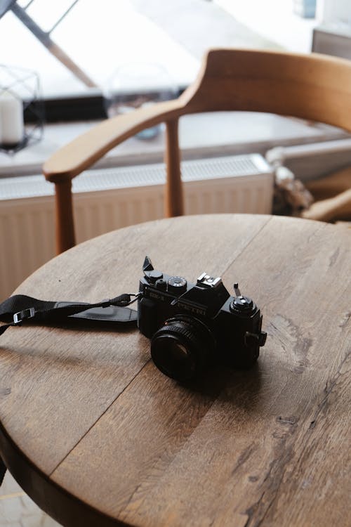 A Vintage Film Camera on a Wooden Table 
