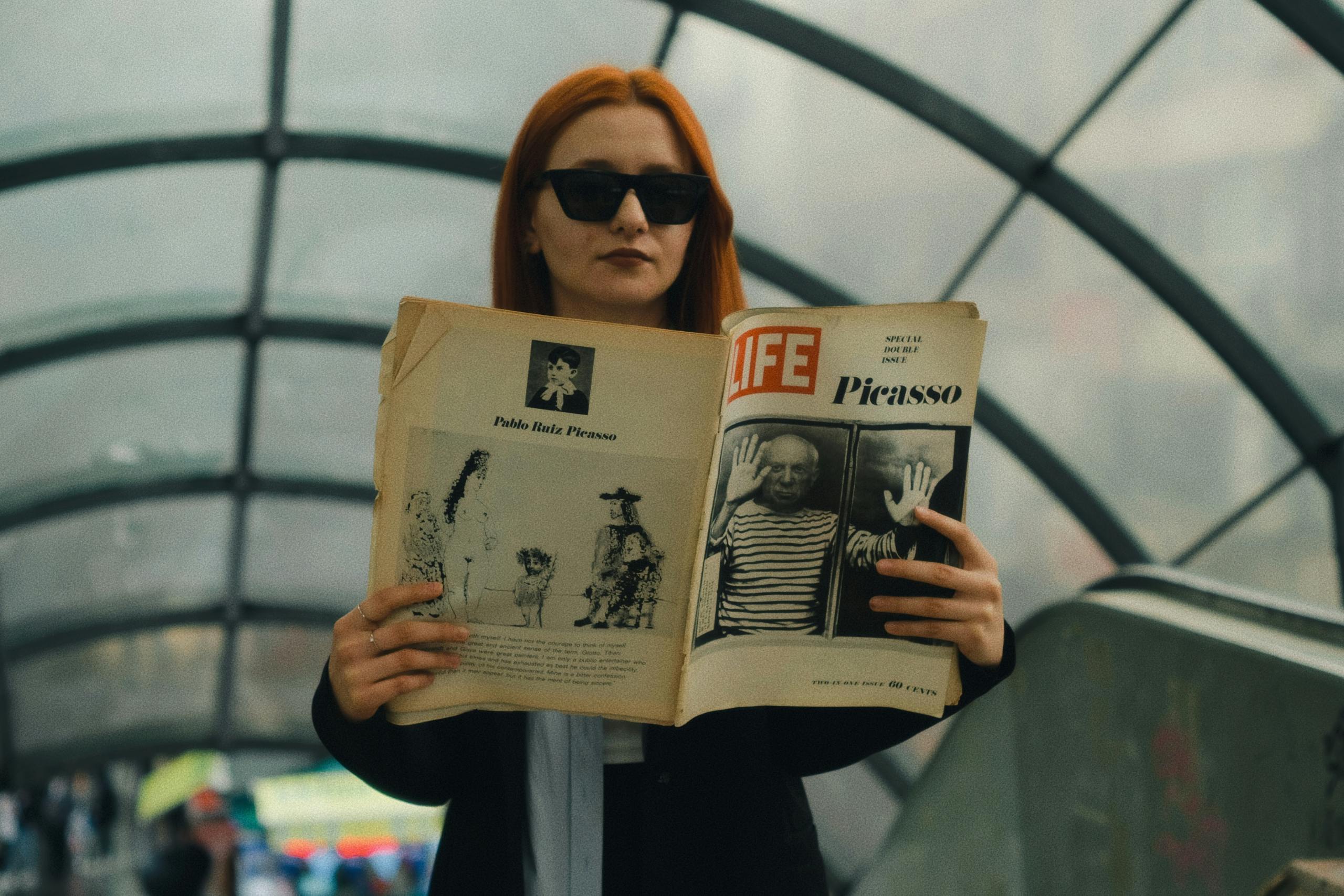 Woman Reading Newspaper in Subway
