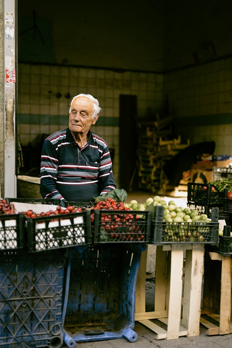 Man Selling Fresh Fruit At A Market 