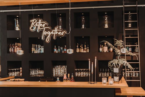 A Modern Bar Counter and Bottles of Alcohol on the Shelves 