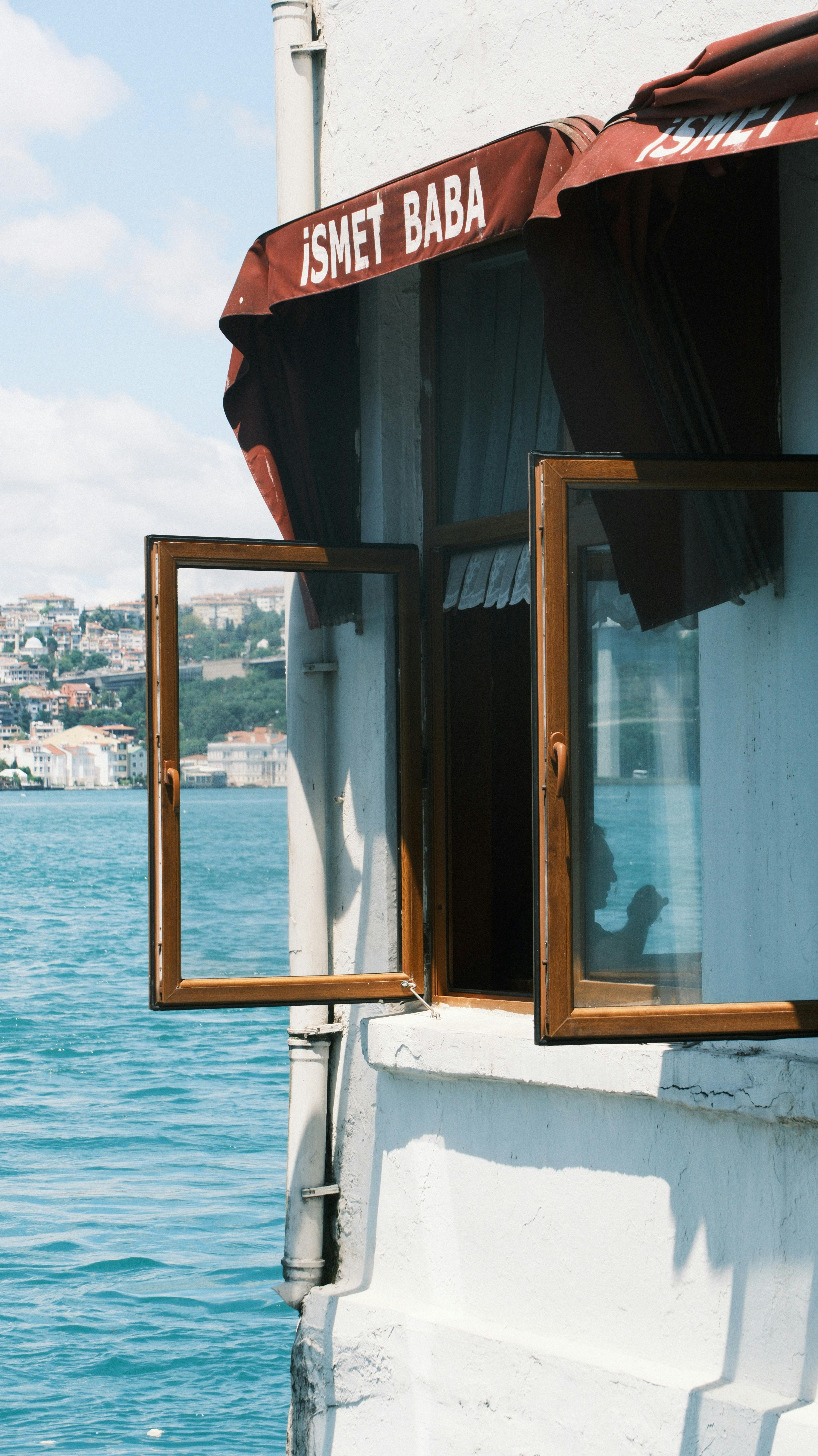 A scenic view through an open window of a building near the Bosphorus Strait in Istanbul, Turkey.