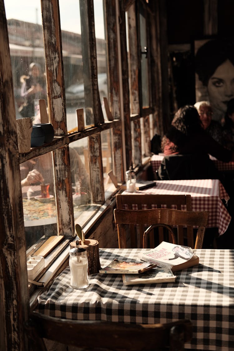 Photo Of People In A Retro Cafe With Wooden Windows