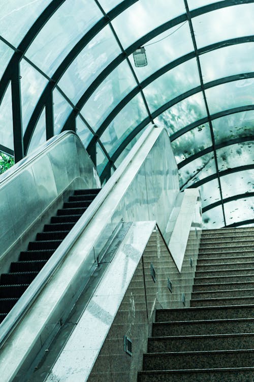 Free Low Angle Shot of Stairs and Escalator at the Exit from a Tunnel  Stock Photo