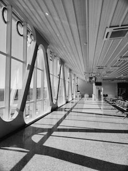 Spacious airport waiting area with large windows and modern design features