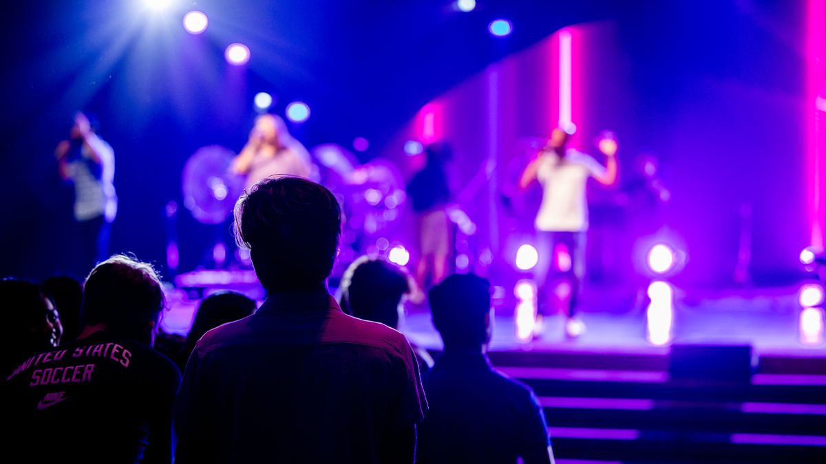 Audience watching musicians perform at a live concert