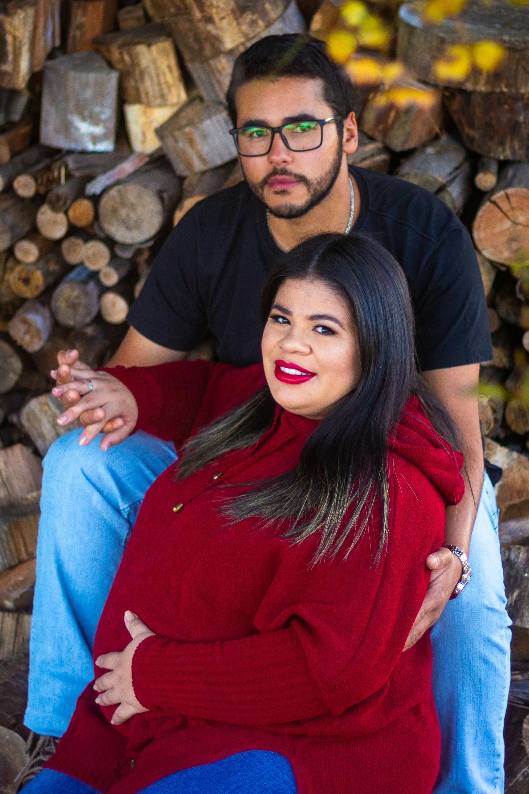 photo of a couple posing with timber in background