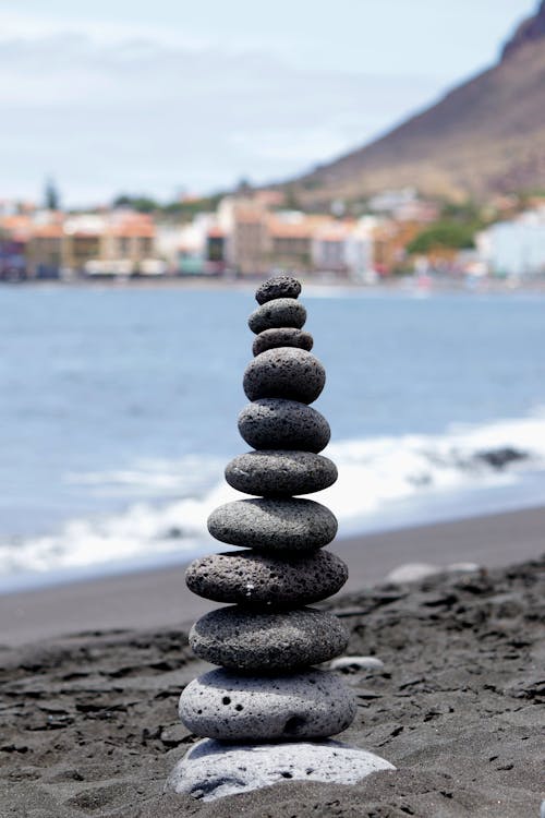 Stack of Balancing Pebbles on a Sandy Beach