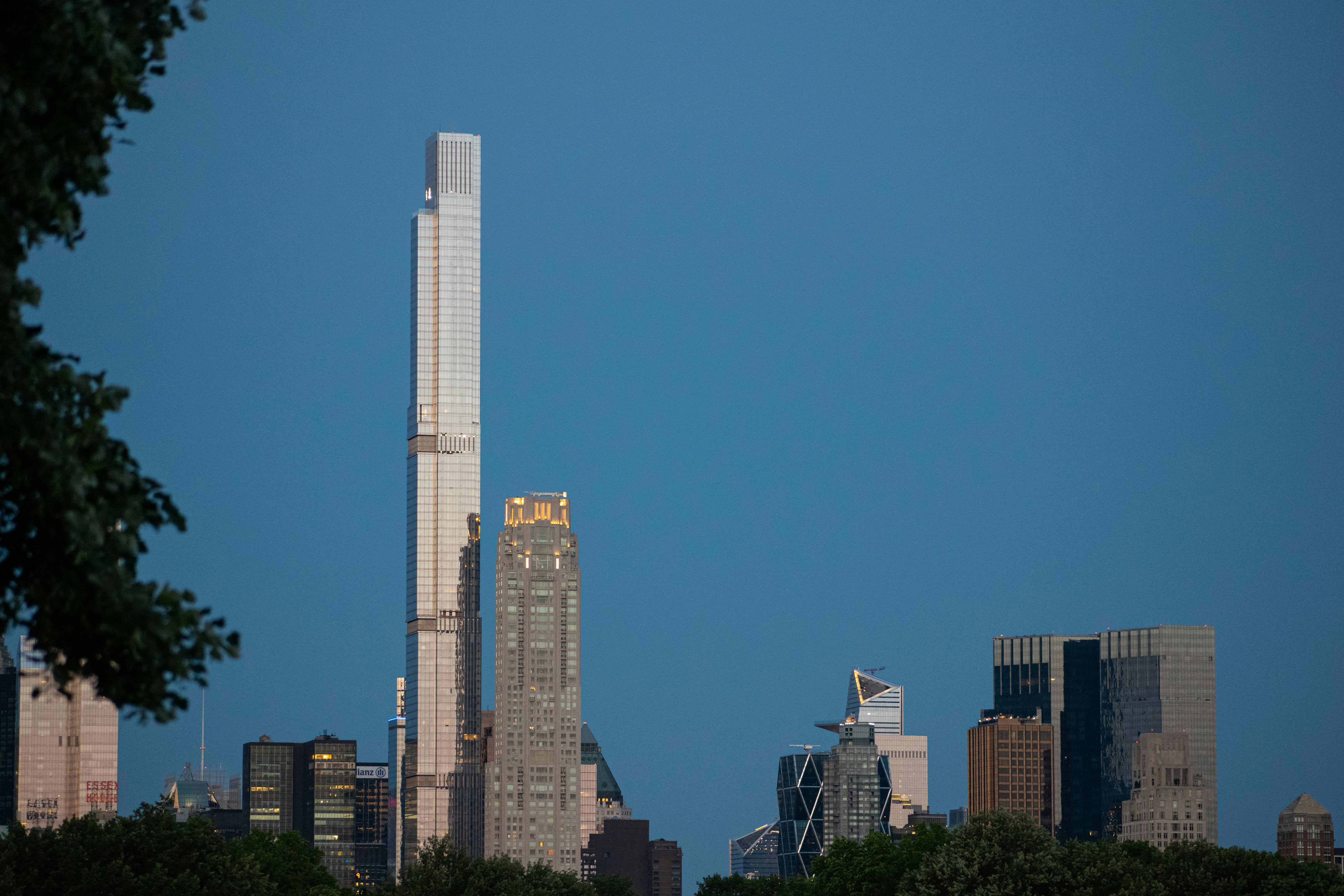 the first light of the day illuminates a billionaire s row supertall skinny skyscraper in manhattan new york city its towering form standing as a testament to architectural grandeur a