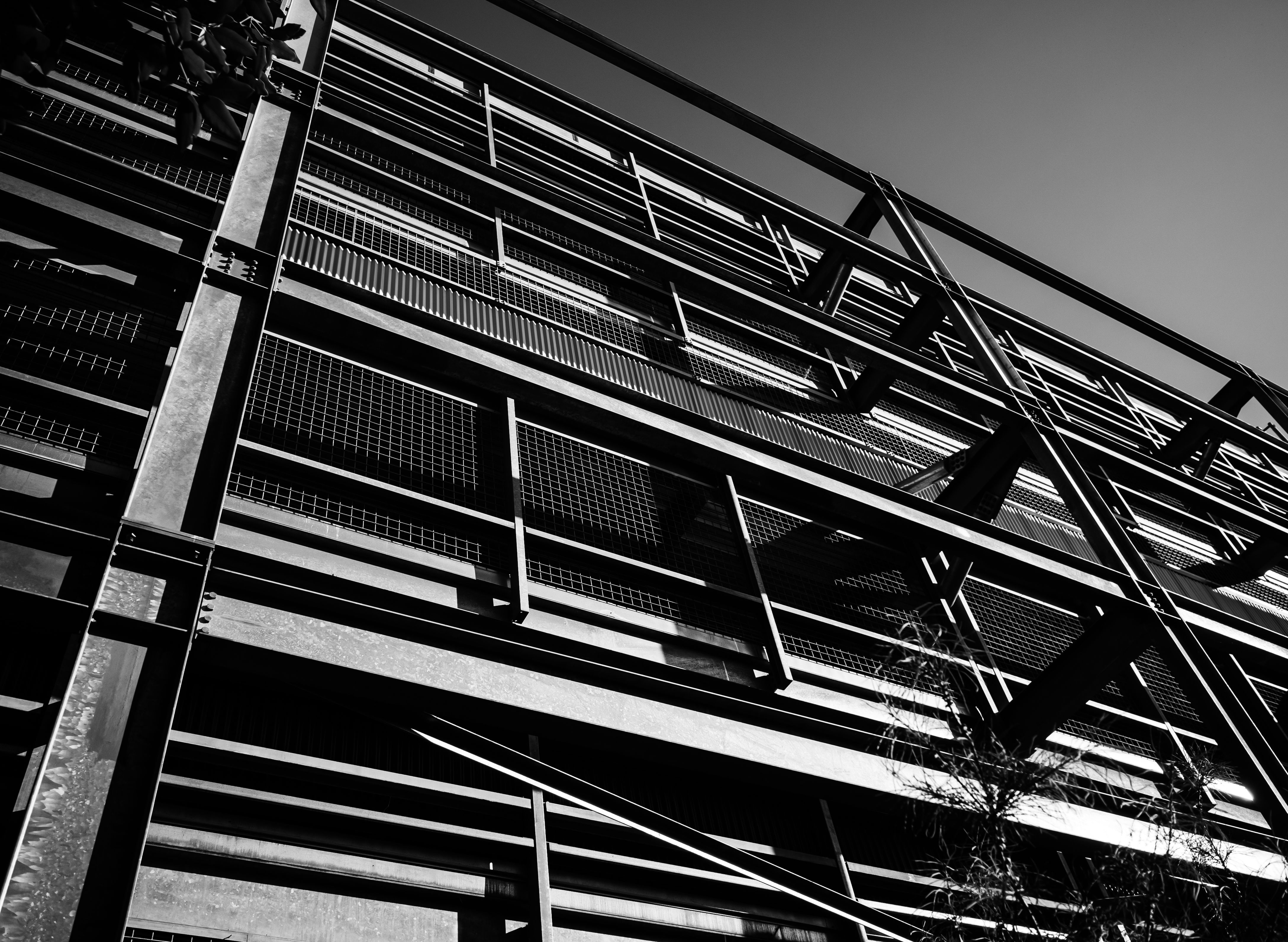 Black and white photo of a modern steel building facade with geometric patterns.