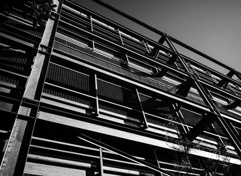 Black and white photo of a modern steel building facade with geometric patterns.