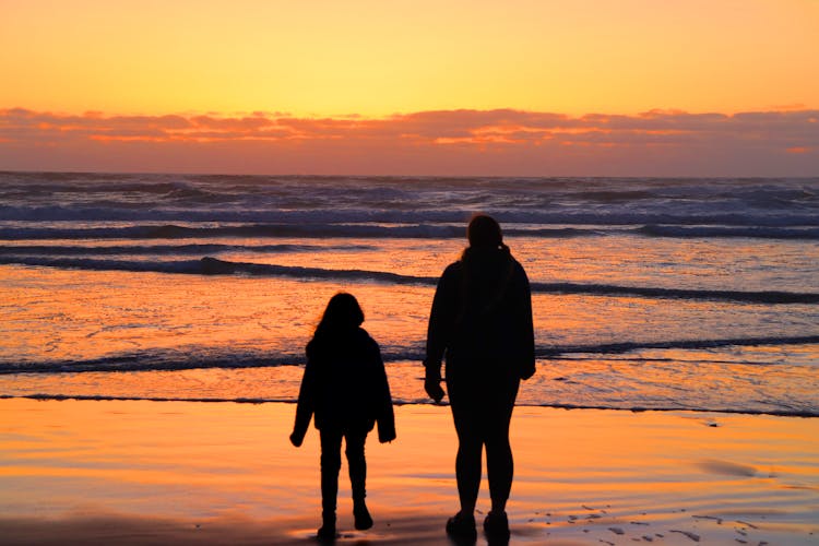 Parent And Child Looking At Sunset