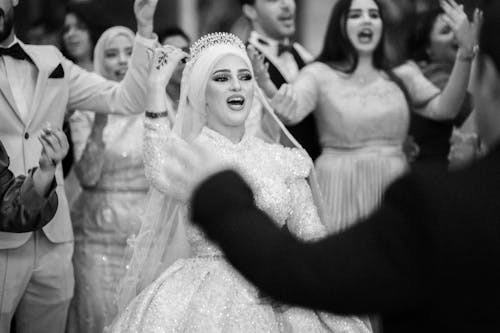 Bride and Groom Dancing at the Reception with Their Guests 