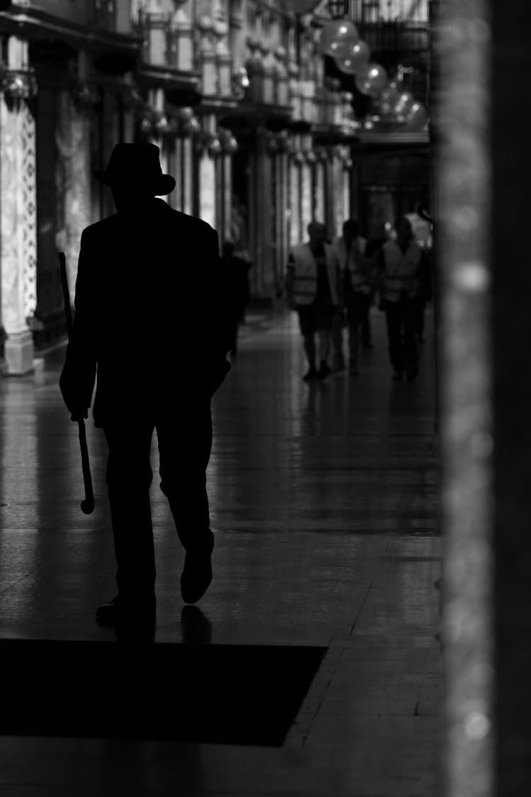 Silhouette Of A Man Walking In The Hallway 