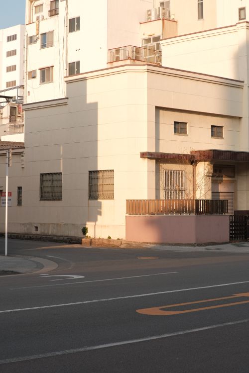 Free Sunlit corner of modern urban buildings with clean lines and shadows. Stock Photo