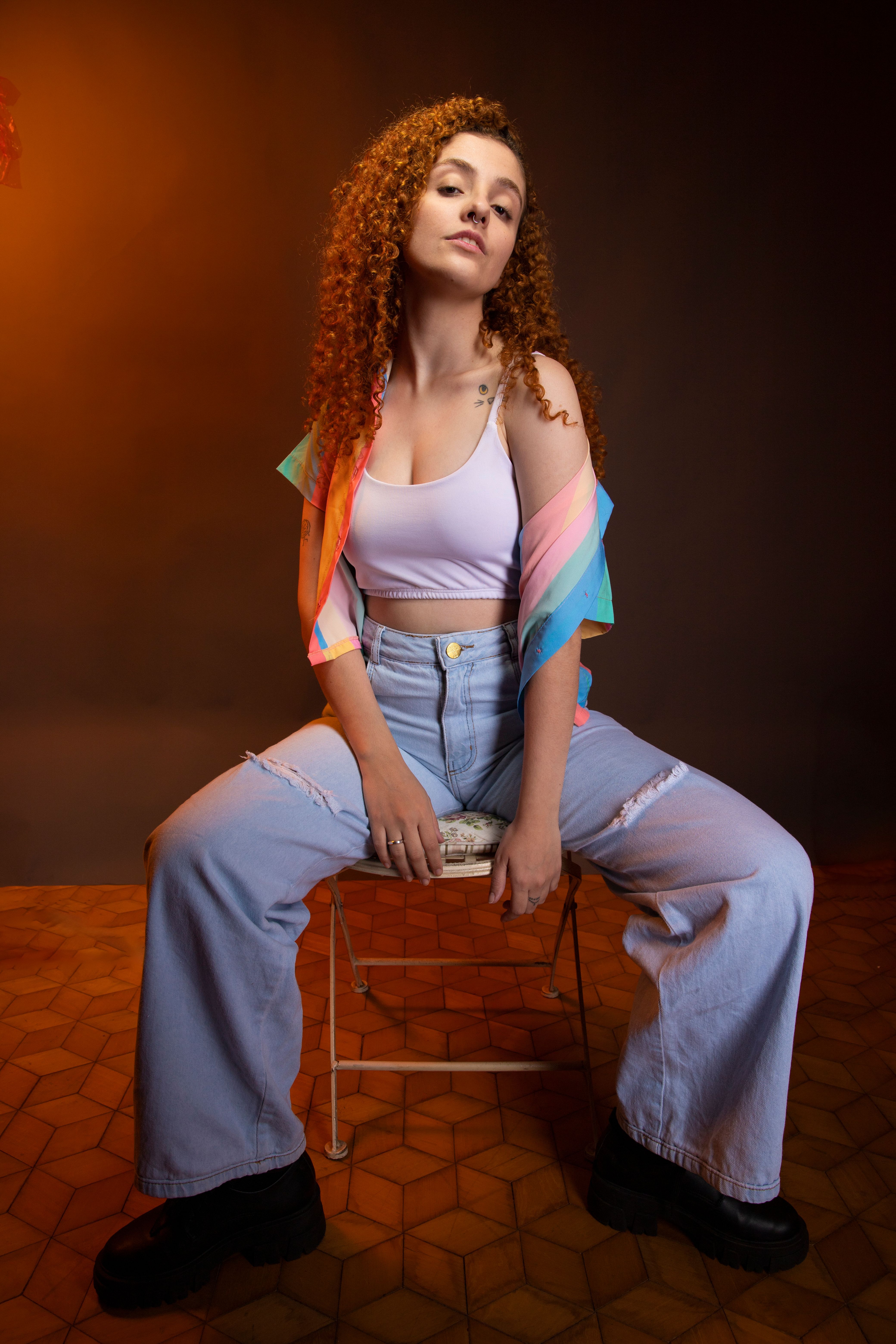 Studio Shot of a Young Woman with Curly Hair Posing in a Casual Outfit ...
