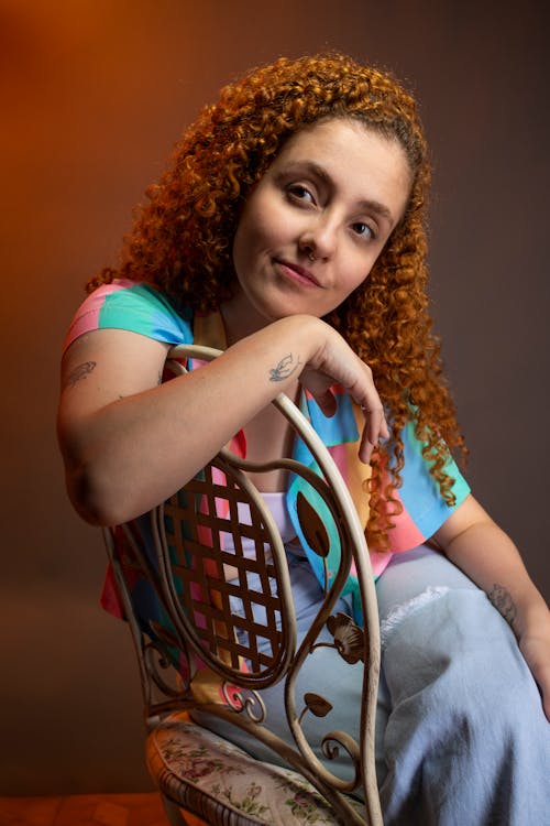 Studio Shot of a Young Woman with Curly Hair Posing in a Casual Outfit 