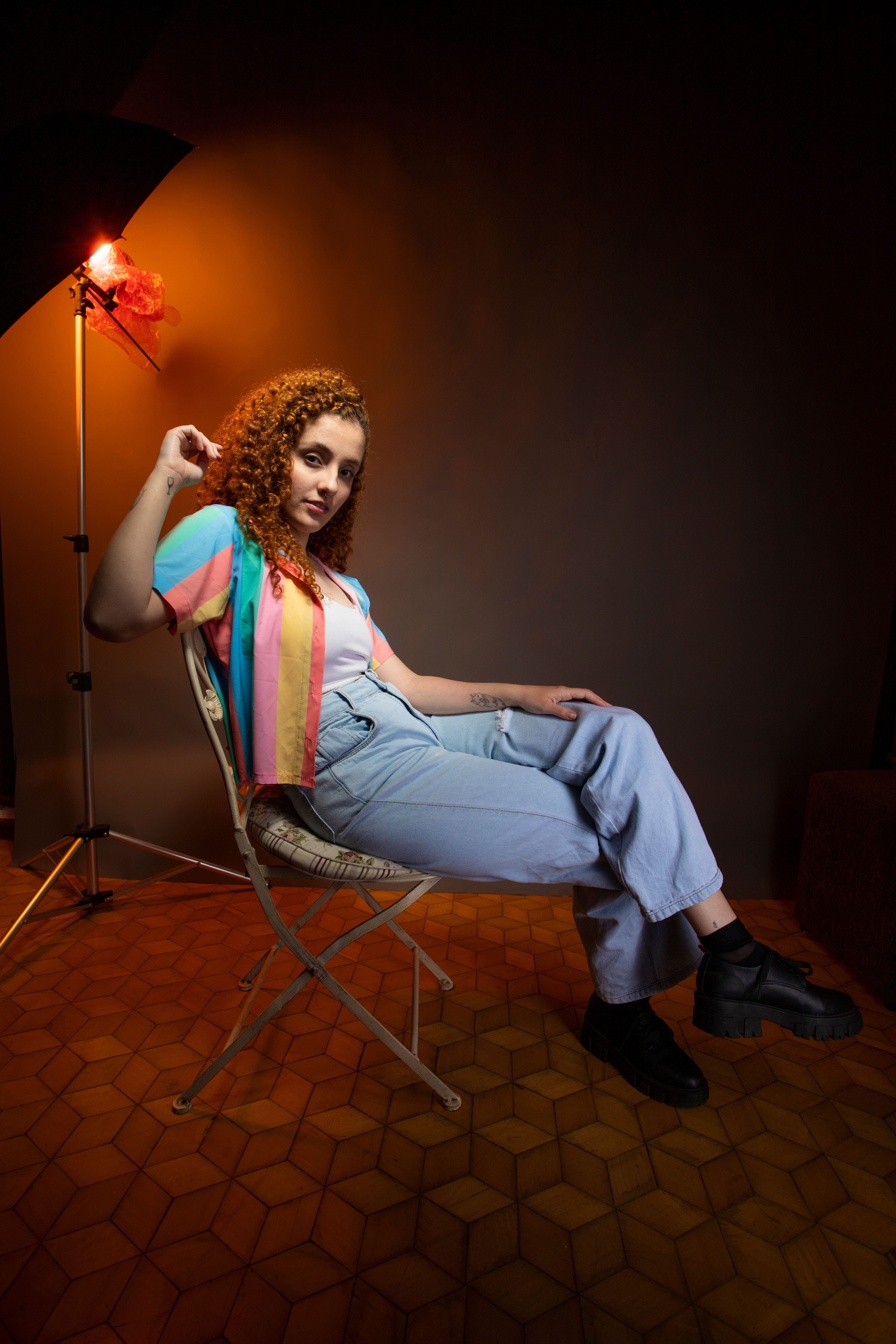 Studio Shot of a Young Woman with Curly Hair Posing in a Casual Outfit ...