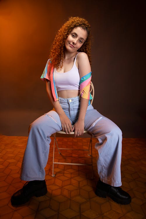 Woman Wearing Jeans Posing on a Chair 