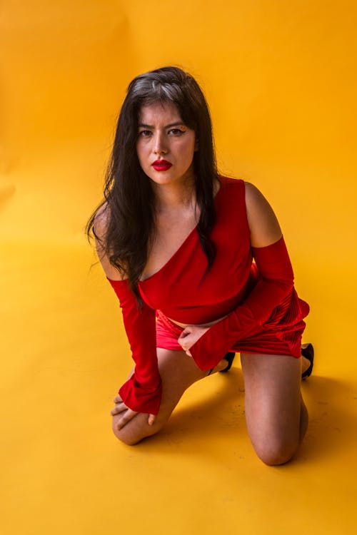 Brunette Woman Posing in Red Asymmetric Dress