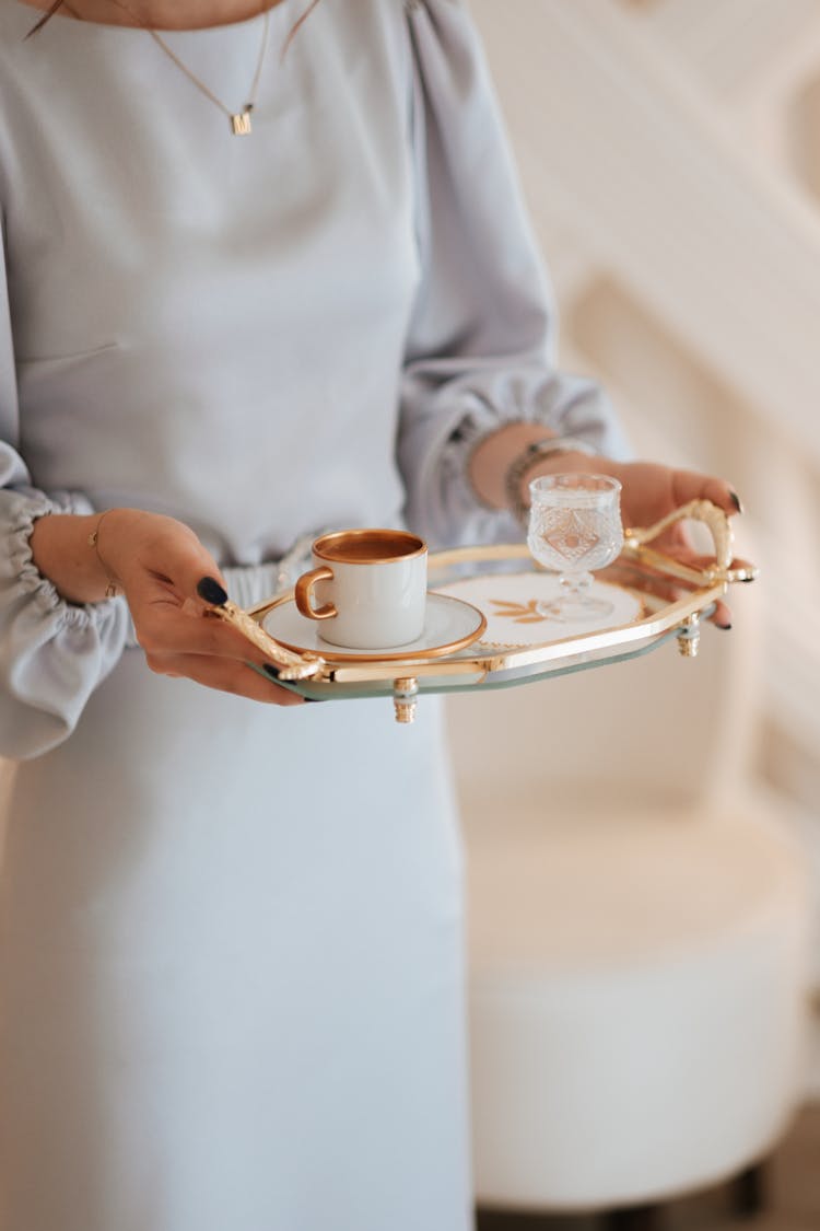 Tray With Coffee And Water In Woman Hands