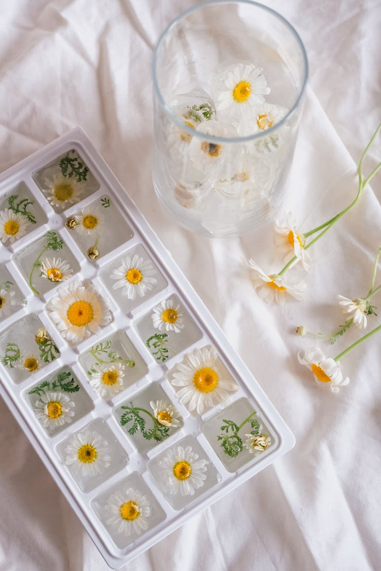 Glass And Box With Flowers