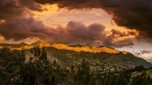 A sunset over mountains and clouds