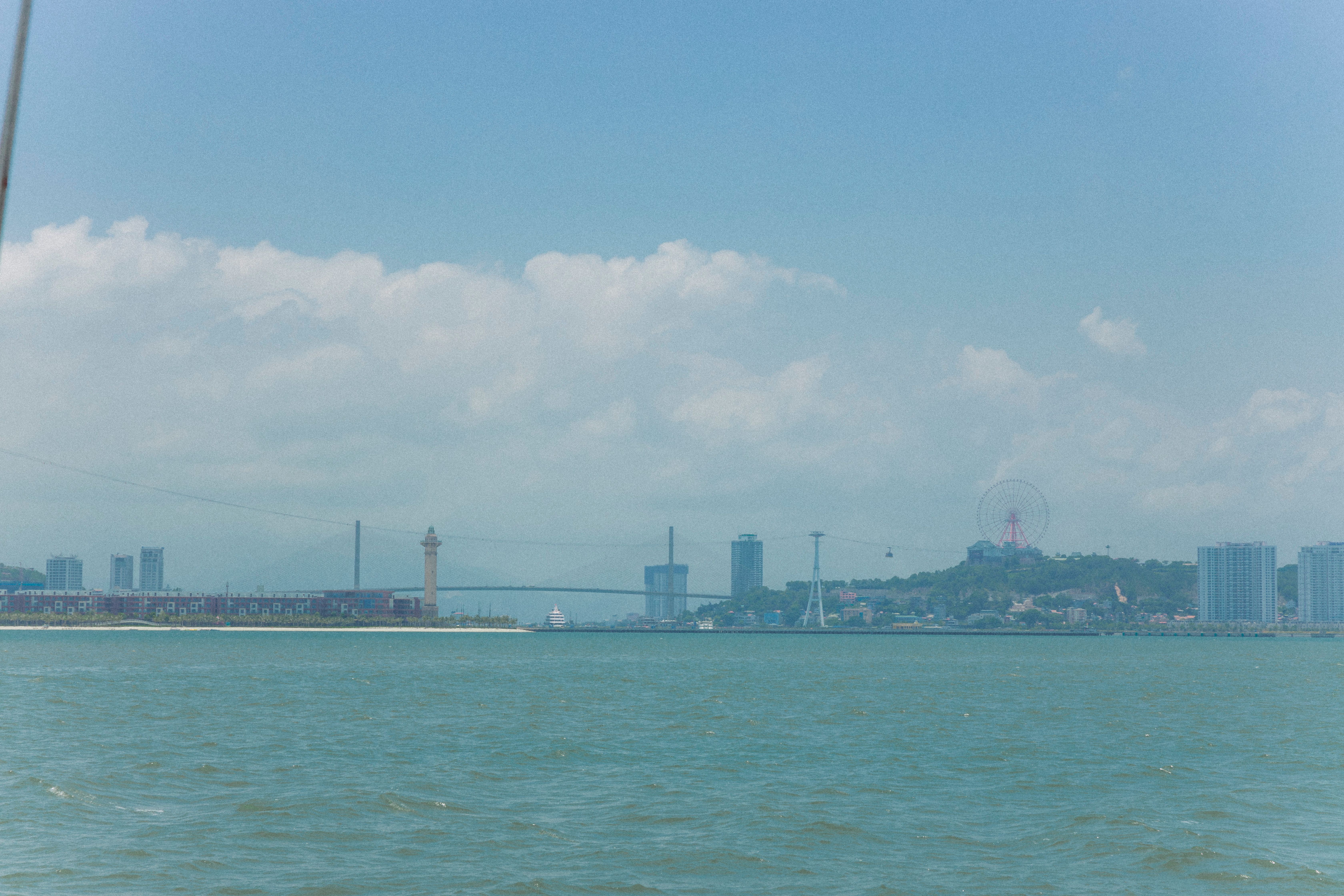 Distant View of a City Waterfront and a Lighthouse · Free Stock Photo