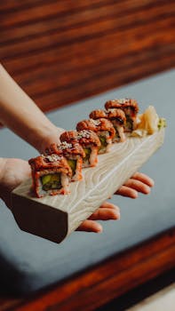 Close-up of vibrant sushi rolls on a wooden platter, showcasing Japanese culinary art.