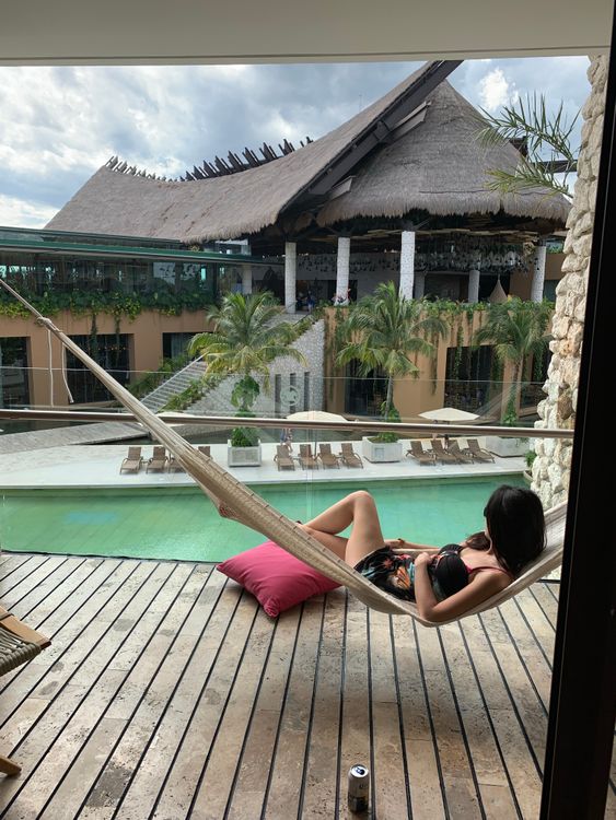 Woman Lying in a Hammock at a Tropical Resort · Free Stock Photo