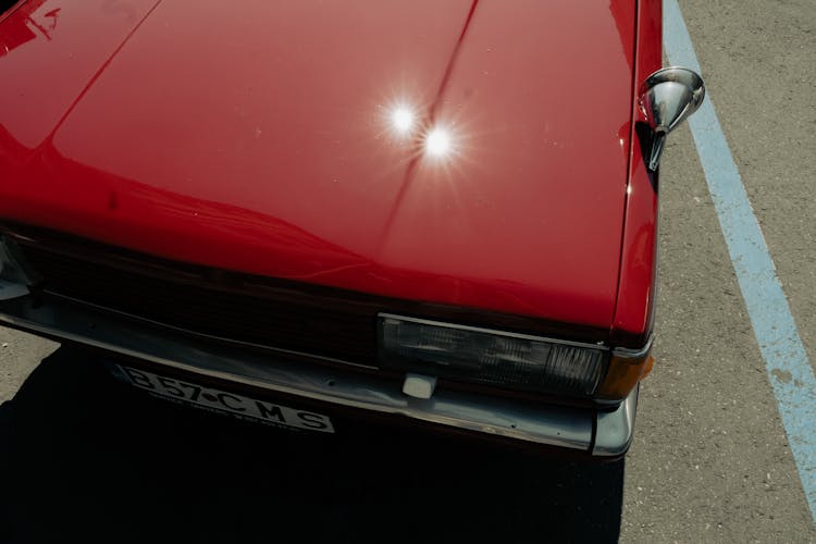 Close-up Of The Hood Of A Red Antique Car 