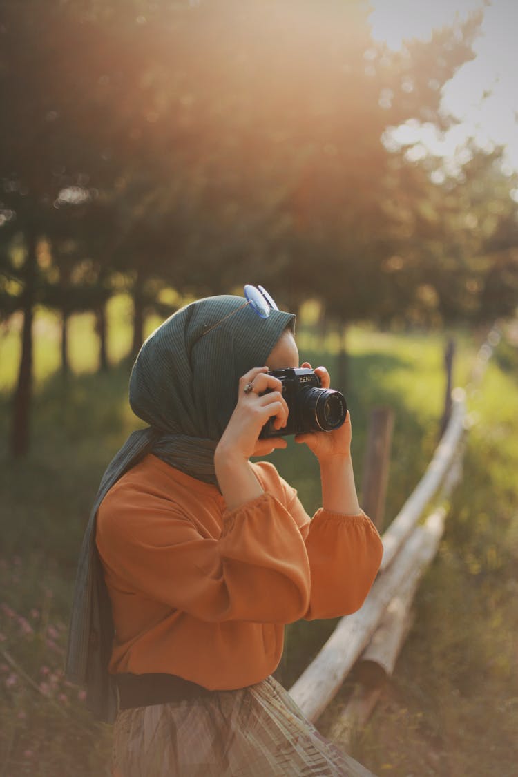 A Woman Taking A Picture In The Park