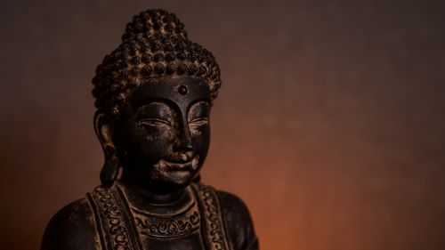 Free A serene Buddha statue with a warm, calming glow in the background, creating a spiritual atmosphere. Stock Photo
