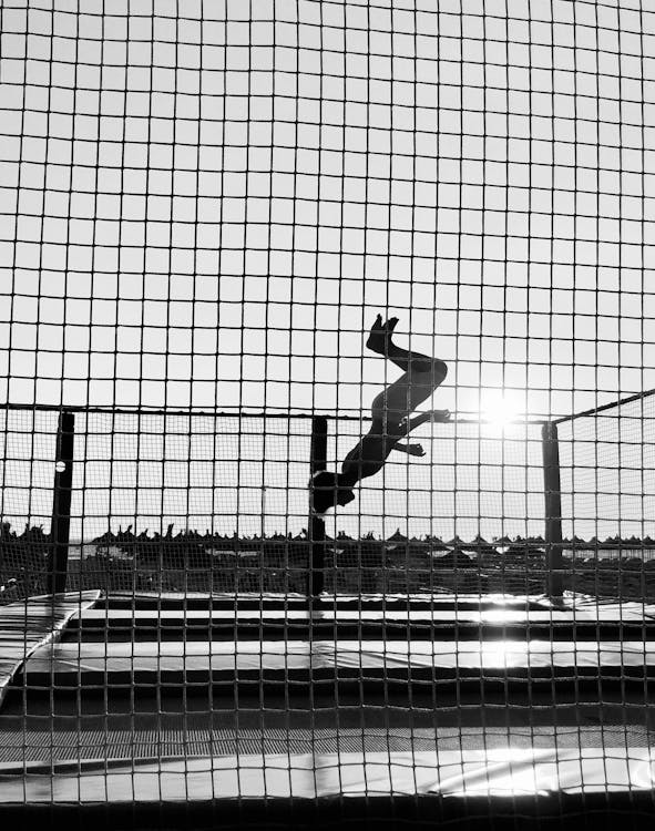 Man Jumping on Trampoline