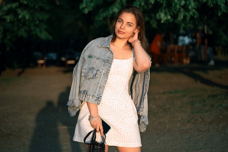 Woman Posing In Dress And Jean Jacket