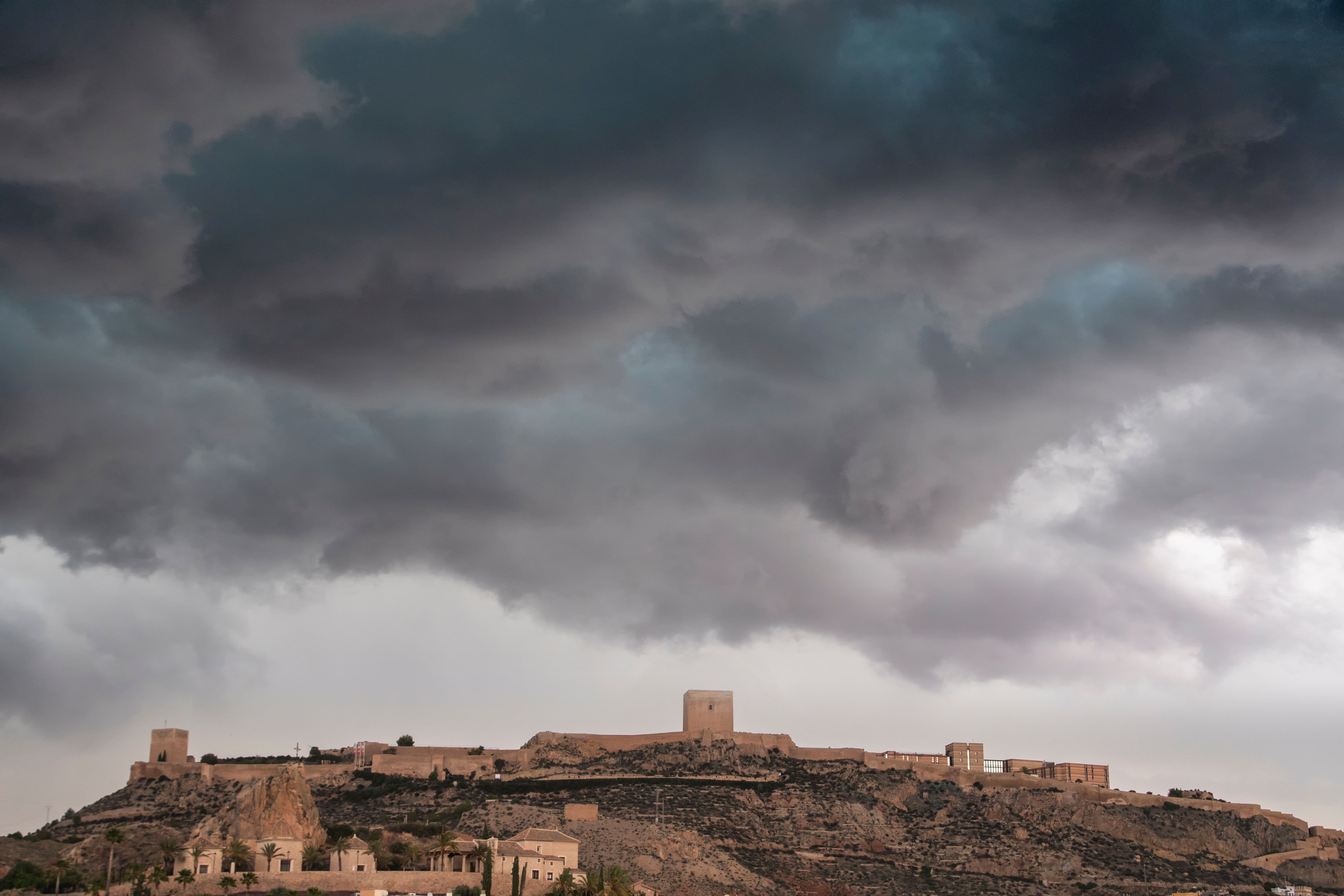 Capture of a medieval fortress under dramatic storm clouds, creating a moody and historical atmosphere.
