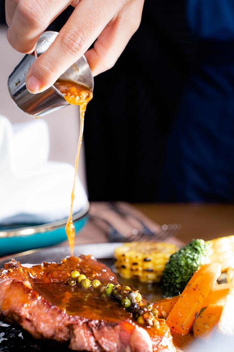 Pouring Sauce On Meat