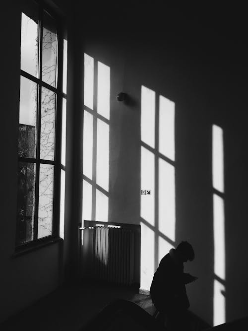 Silhouette of a Man Walking down the Stairs 