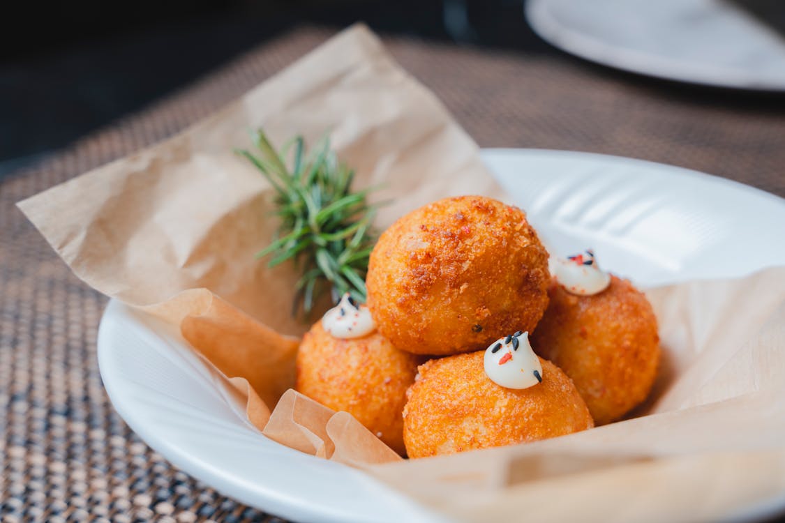 A plate of food with cheese and herbs on it