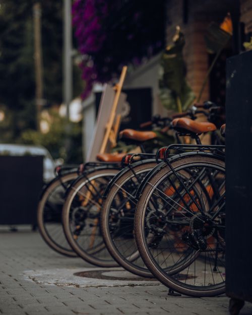 Free Vertical shot of bicycles lined up on a city sidewalk, perfect urban transport scene. Stock Photo