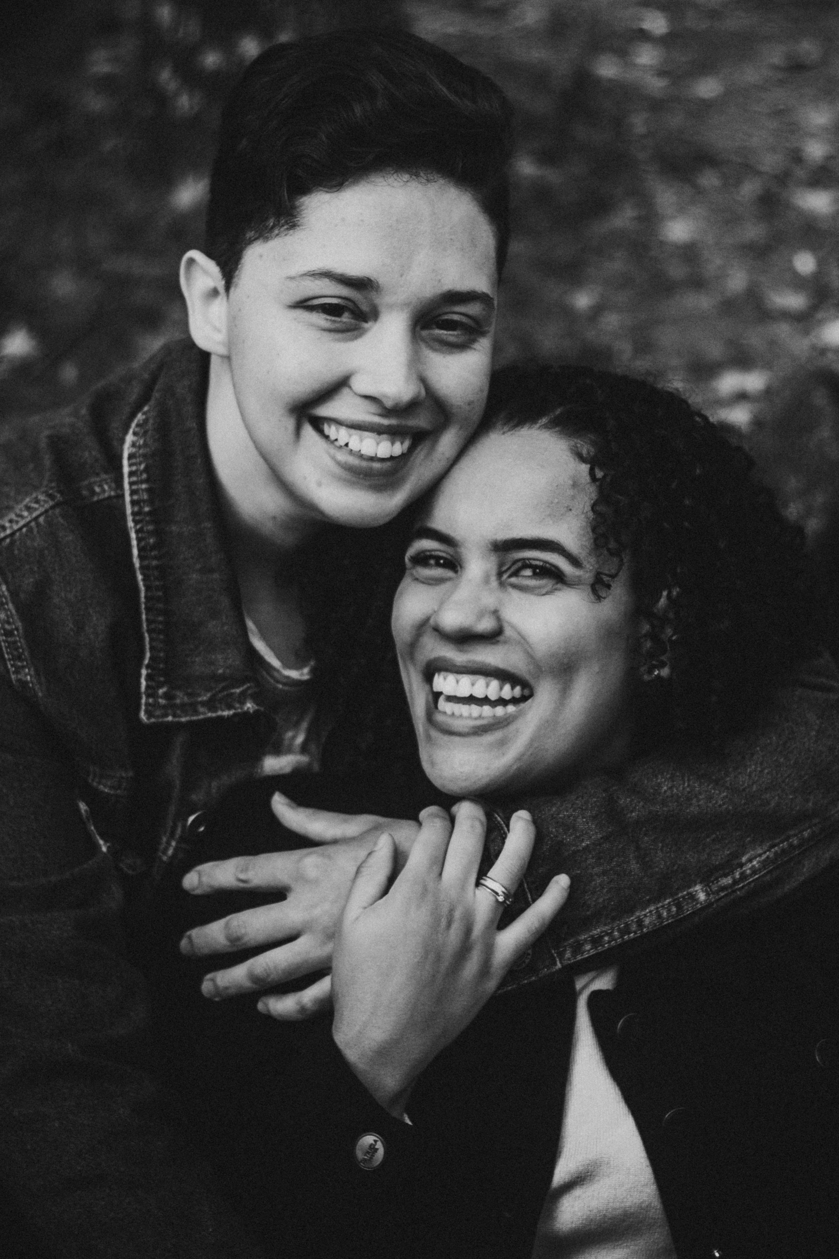 Black and white portrait of a joyful couple embracing and smiling, capturing a moment of love.