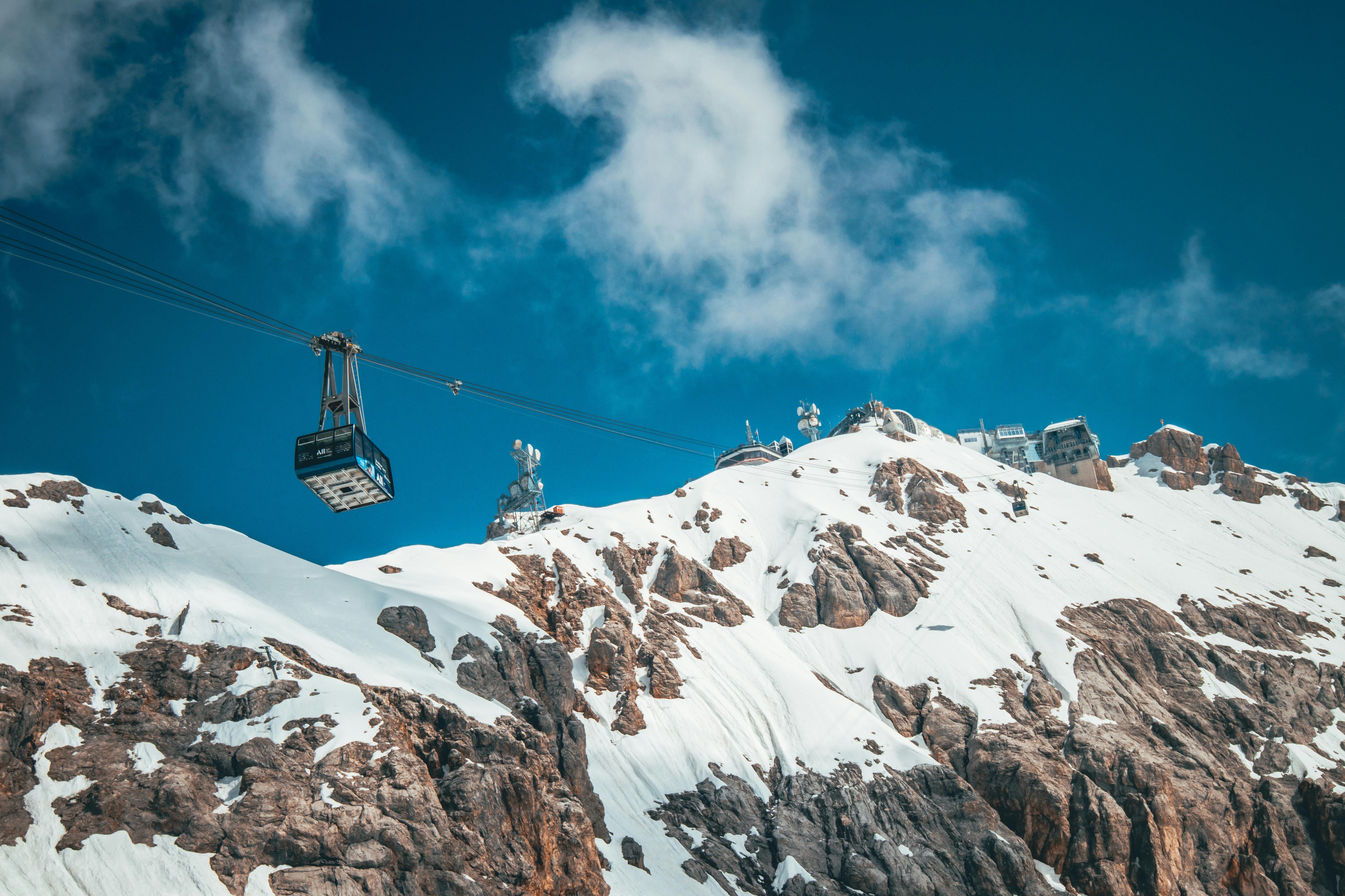 Prescription Goggle Inserts - Cable car ascends over snow-covered mountains in a stunning winter landscape.