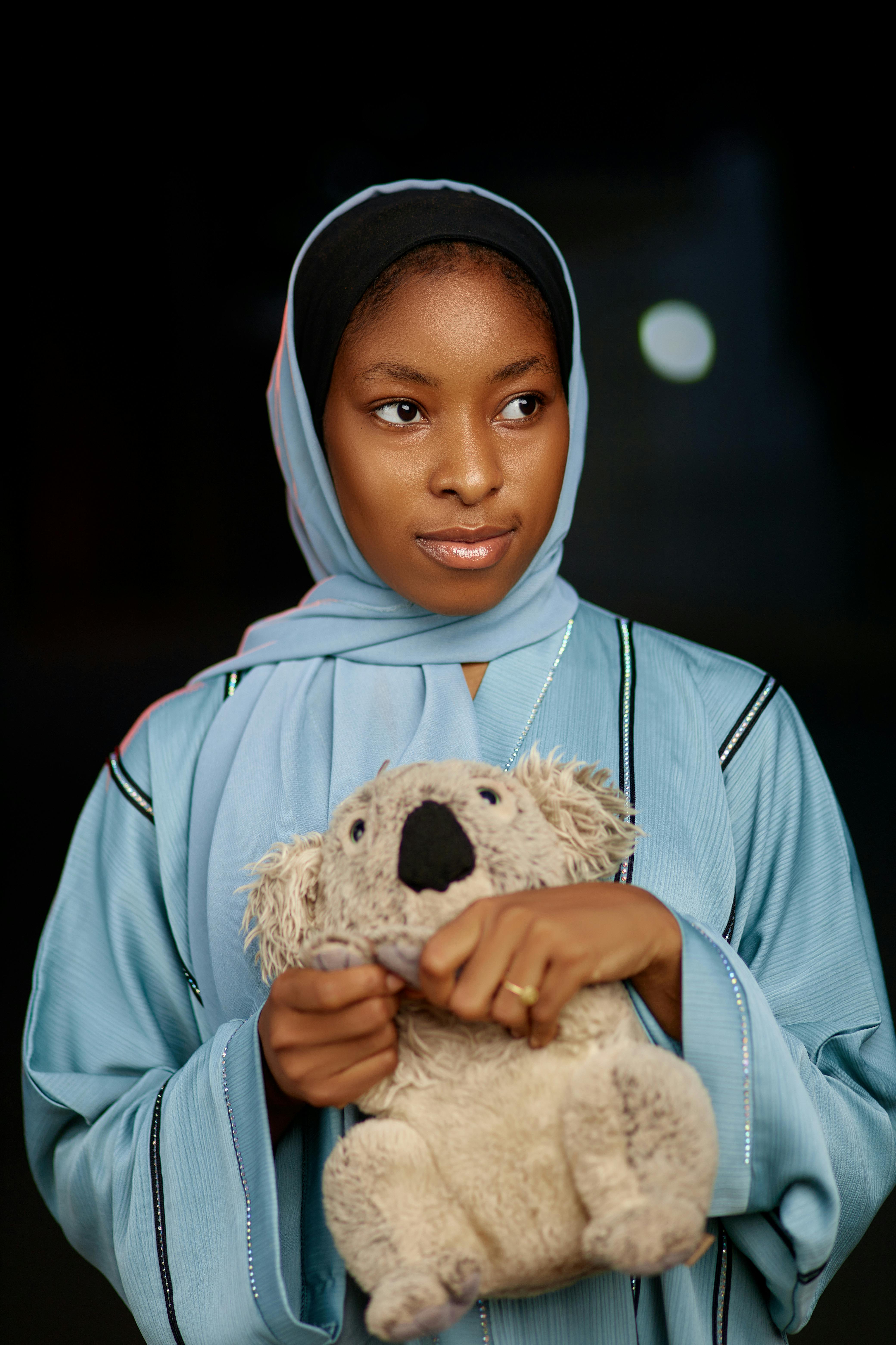 young woman holding a koala bear teddy bear