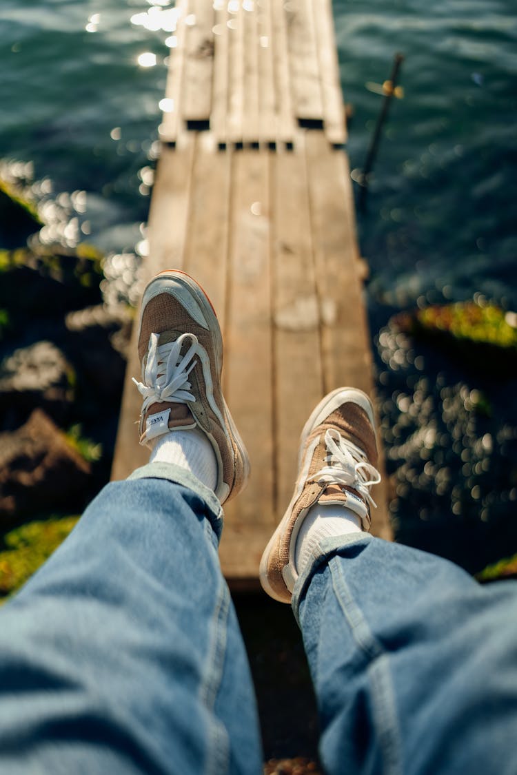 Photo Of Legs In Jeans And Sneakers